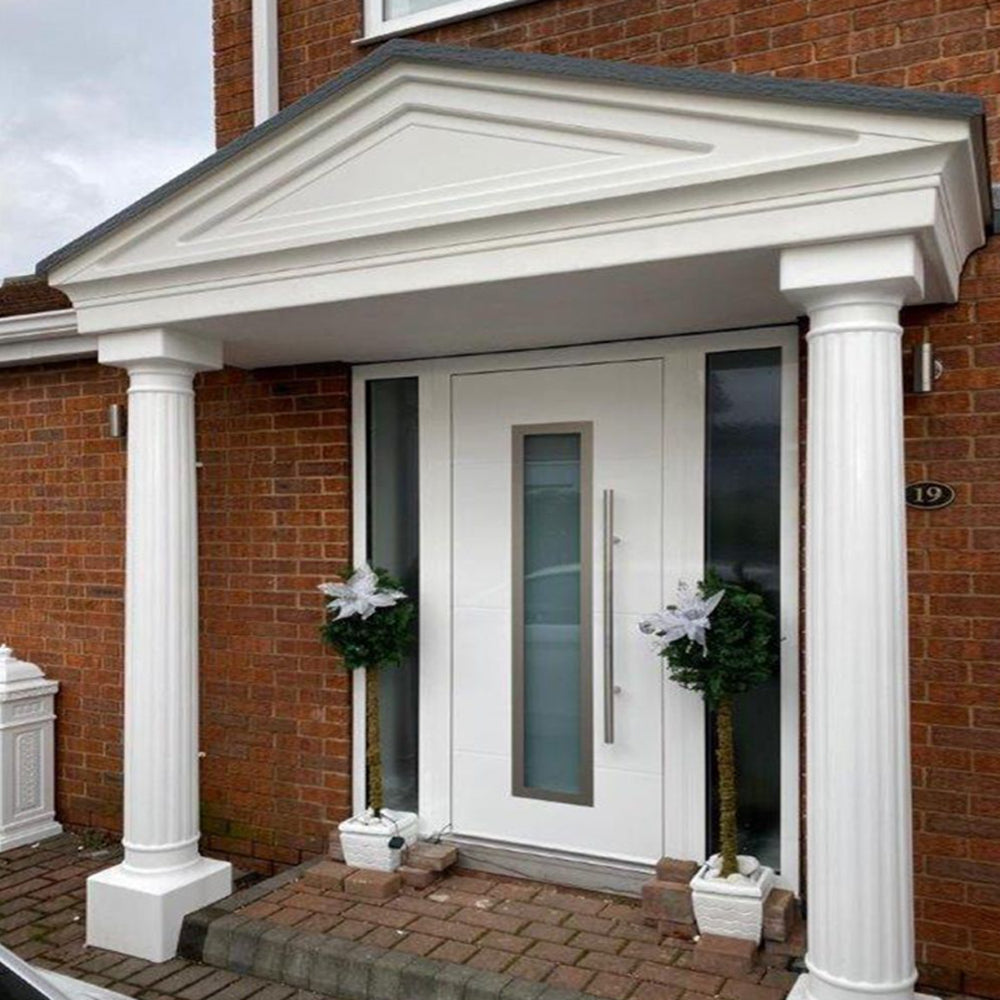 White front door with decorative columns on a brick building with portico