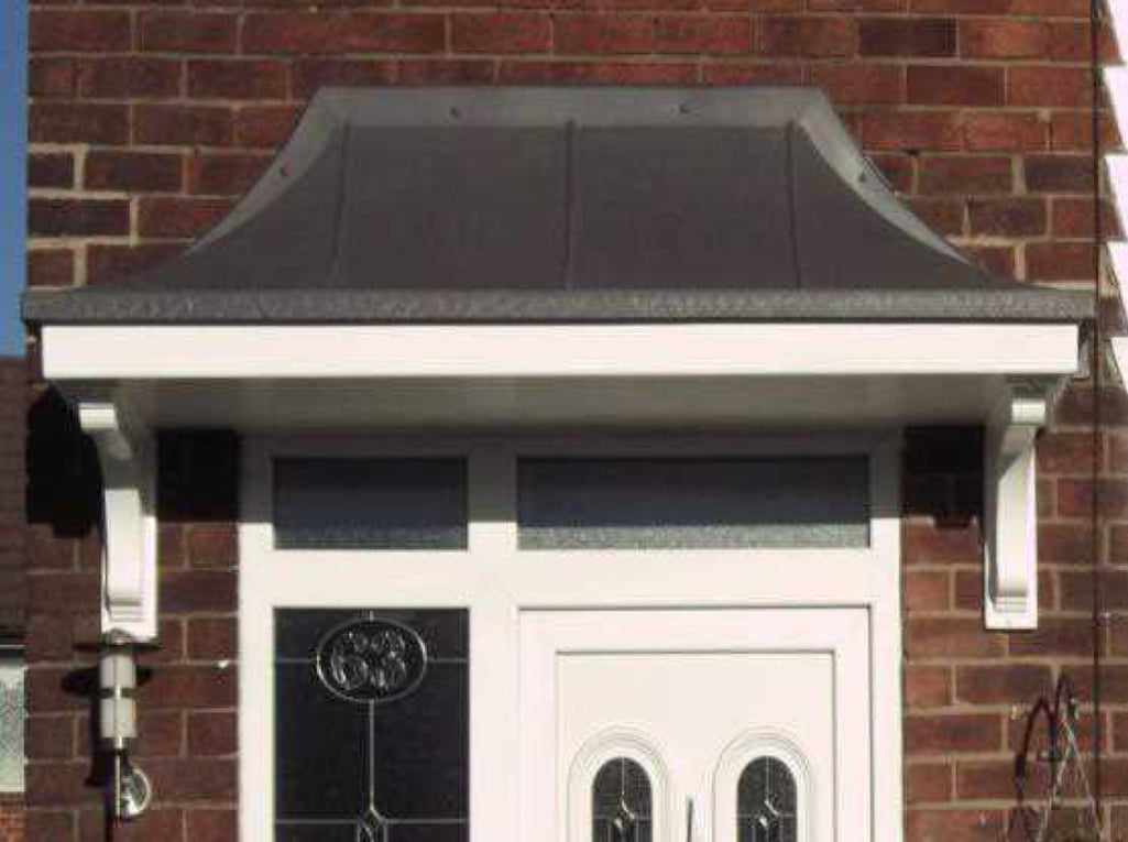 bell shaped overdoor canopy above white front door with window panel